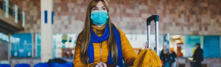 woman with mouth mask waiting at airport